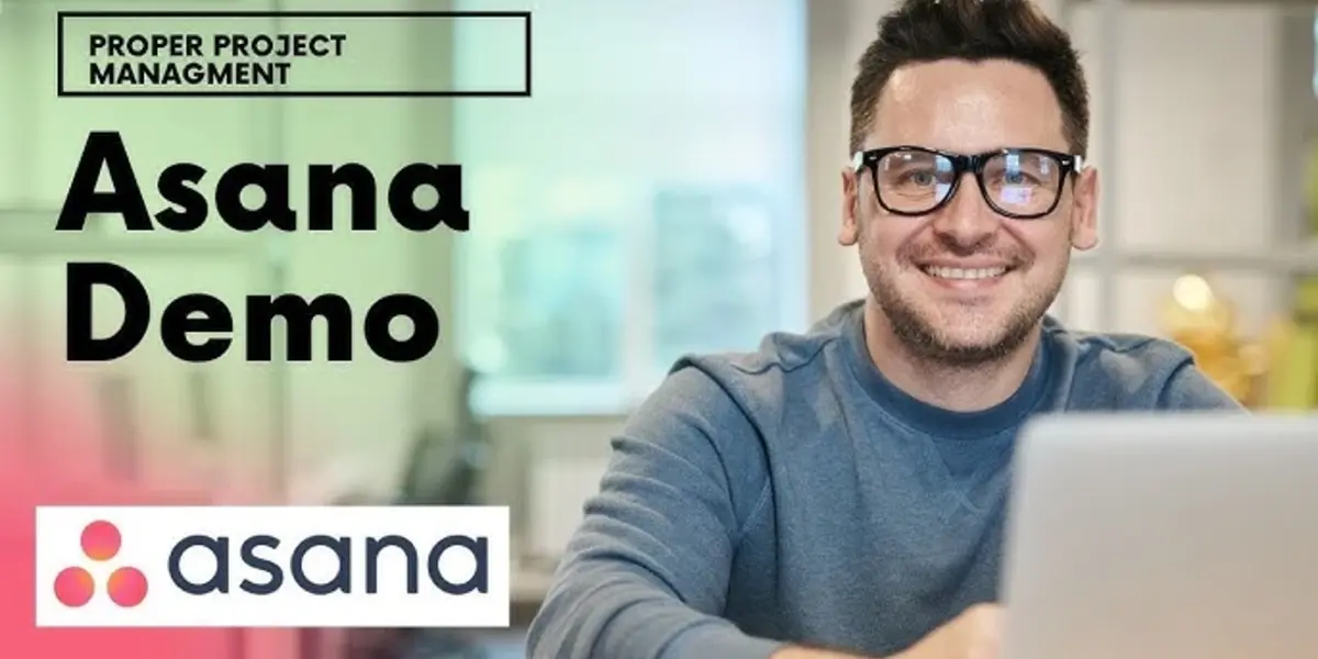 Smiling man wearing glasses working on a laptop with text 'Proper Project Management - Asana Demo' and the Asana logo.