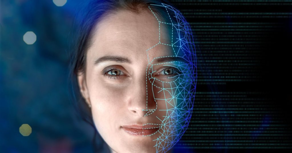 A woman's face partially covered with a digital mesh and binary code, representing AI and advanced technology in facial recognition or digital content generation.